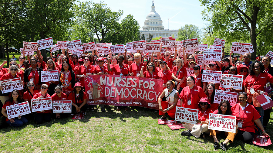 Large group of nurses outside D.C. Capitol building holding signs "Medicare for All"